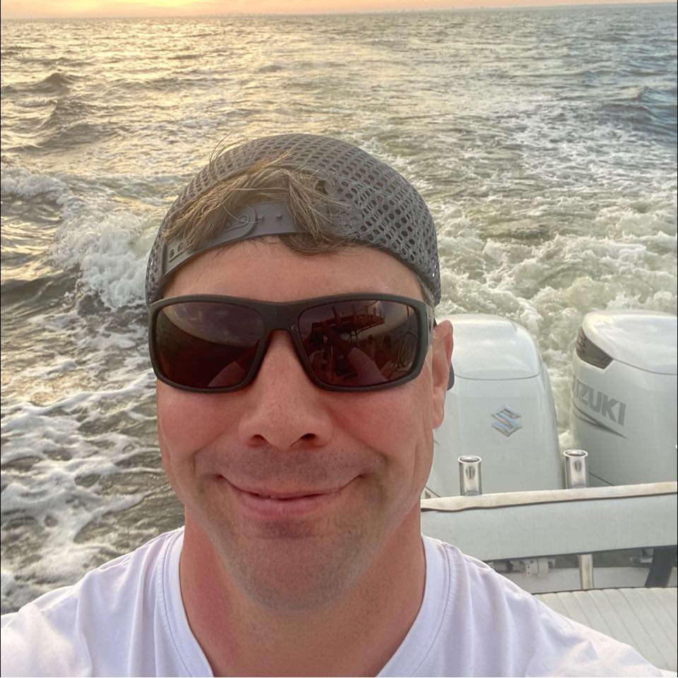 Captain Wilson Hester on the water at sunset